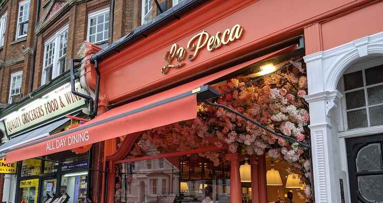 The restaurant's vibrant orange exterior brightens up the high street