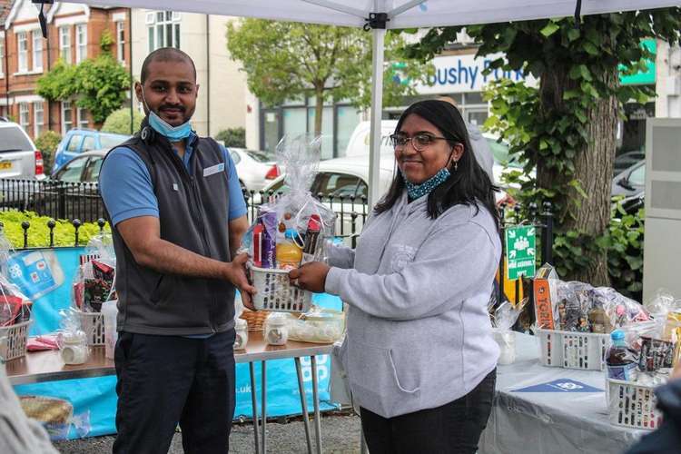 A helping hand: Amila with the winner of Teddington Co-op's raffle in aid of Mind (Image: Maria Nastri)