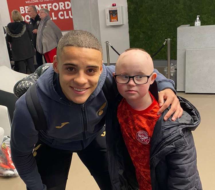 Teddington boy Woody went in for a hug with England player Max Aarons after Saturday's Brentford match (Image: Natalie O'Rourke)