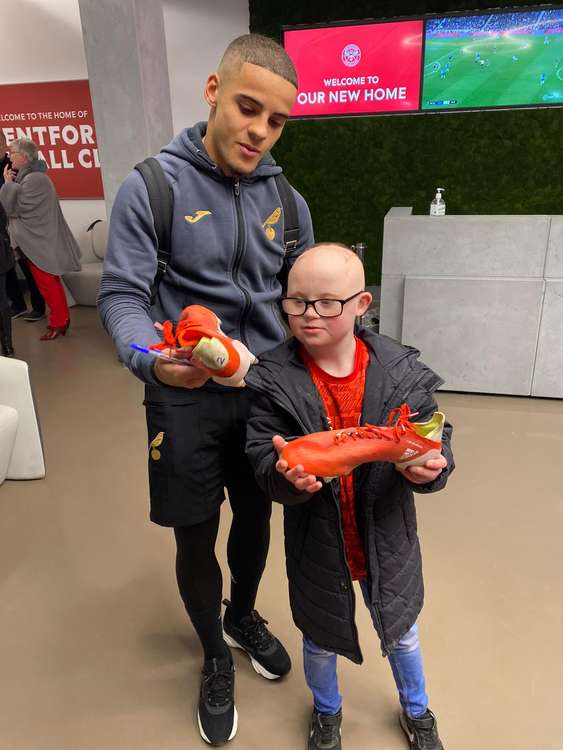 To Woody's delight, Aarons took off his match boots, signed them and handed them over as a gift (Image: Natalie O'Rourke)