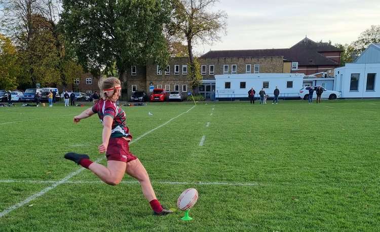 A Thamesians Ladies player goes in to kick the ball (Photo: Lara Miller)