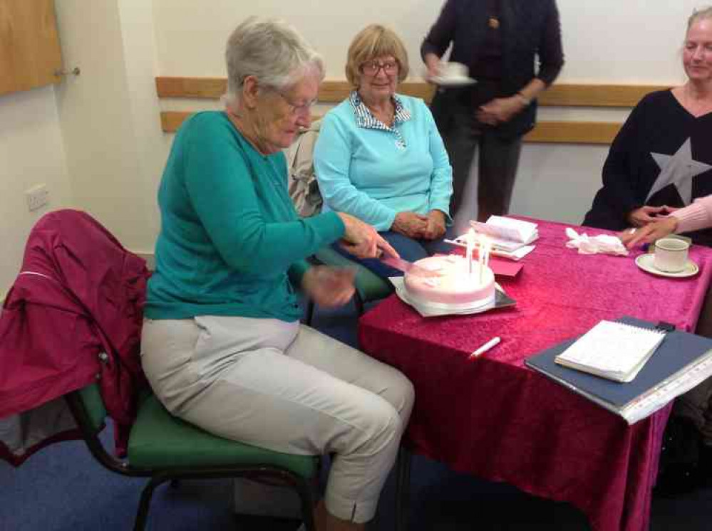 Kay Lawrence cutting her cake prior to the meeting starting.
