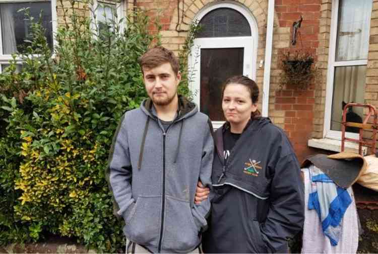 Josh Baker with partner Sophie Hudson outside where they live on Victoria Terrace, which was badly affected by the flooding.