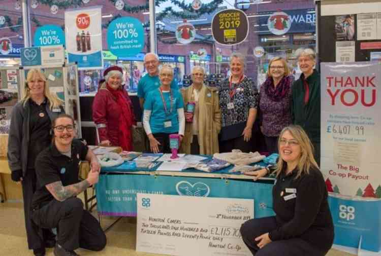 Pictured: Co-op management, Kathryn Baker and Alex Miller along with ,members of the Honiton Carers Support Group at Honiton Co-op in Lace Walk. Image credit: David Smyth Photography