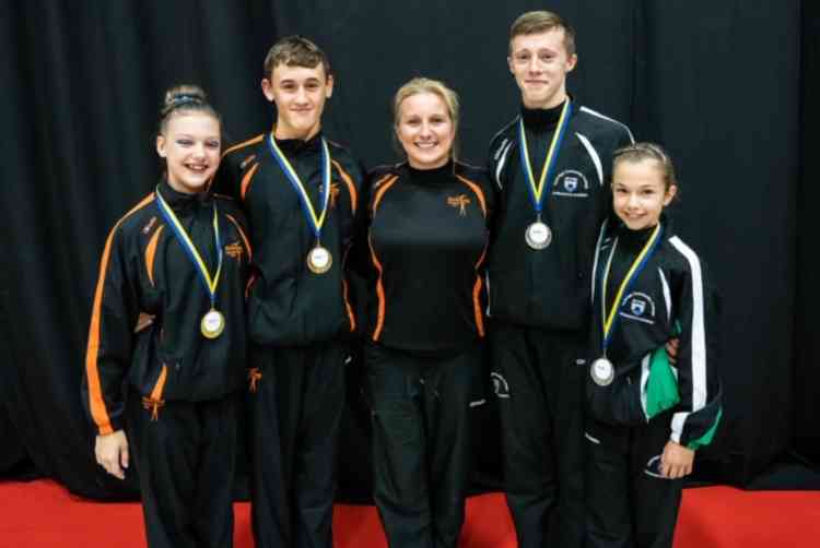 Helen Reddy (centre), who is being awarded an OBE for Services to Educational Gymnastics, with Honiton and Ivybridge gymnasts.