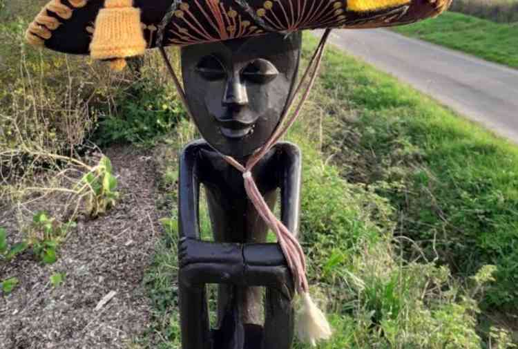 Enoch the African-style carving wearing a sombrero