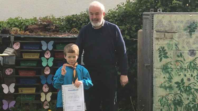 Ernie with his Investiture Certificate with a happy Grandad.