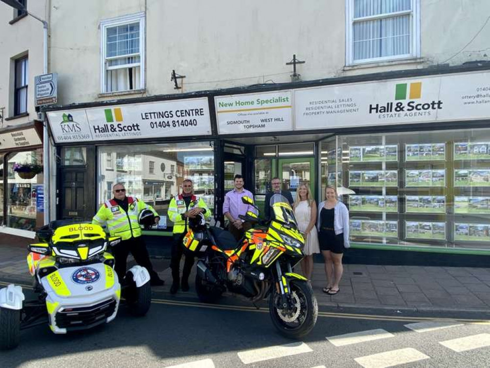 Photo shows: Staff at Hall & Scott Estate Agents outside the Ottery St Mary branch with Devon Freewheelers volunteers. Credit: Devon Freewheelers