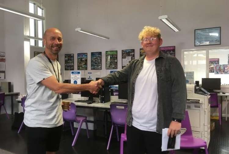 Principal Glenn Smith congratulates Ellis, who was awarded the 'Reading List Foundation' award for his academic and personal success throughout his time in Post-16.