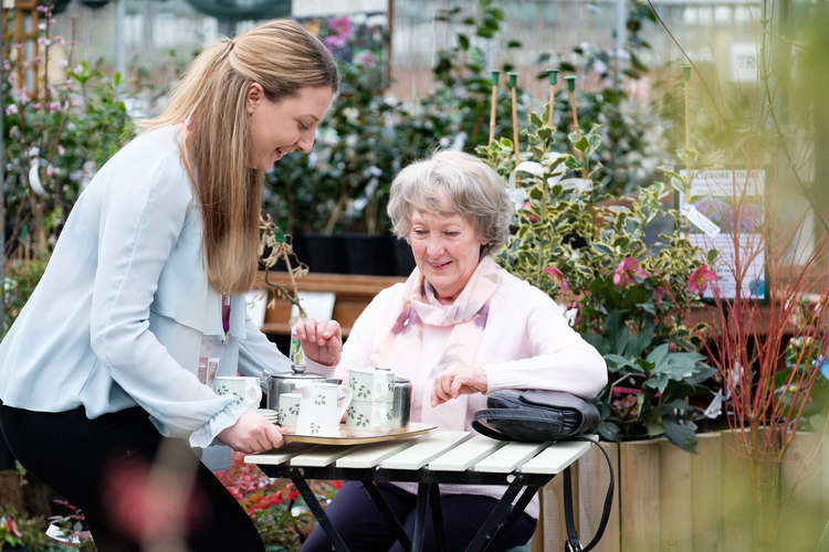 A Home Instead CAREgiver serves tea to a client. Picture: Home Instead