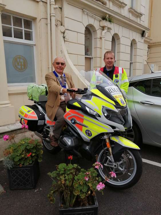 Photos show members of the Torquay and District Scottish Society with one of the Devon Freewheelers Blood Bikes and volunteer and rider Rob Meadows, who received a cheque for £550 on behalf of the charity. Photo: Torquay and District Scottish Society