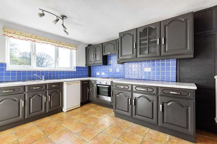 The kitchen benefits from fitted units with a built-in oven and hob and space for appliances