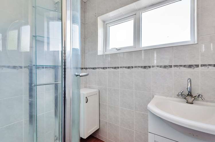 The shower room has a corner walk-in shower cubicle and separate WC