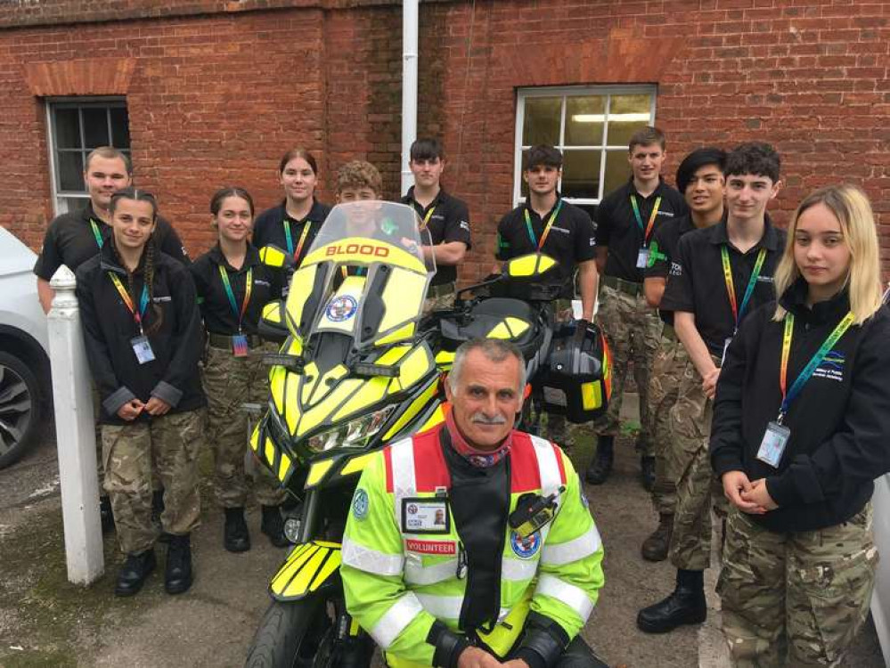 Photo shows: Devon Freewheelers volunteer Dave Cook Military with the Protective Services Academy students, at Bicton College, in East Devon. Credit: Devon Freewheelers.