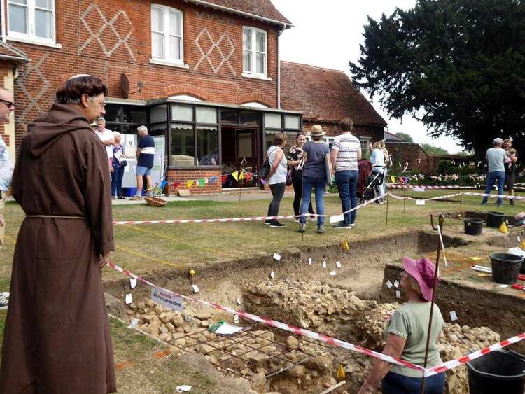 A medieval monk talks to a digger