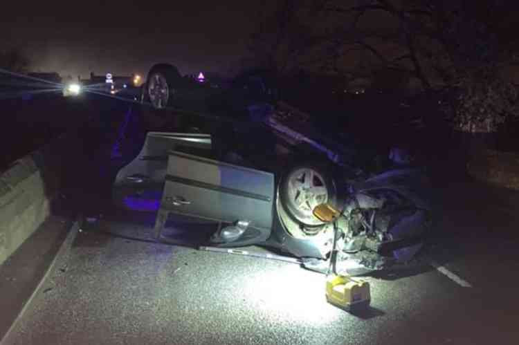 A car was left on its roof on Swarkestone Bridge. Image: Derbyshire Fire and Rescue Service