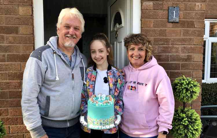 Dad Dave, birthday girl Saskia and mum Joanna with the specially made cake