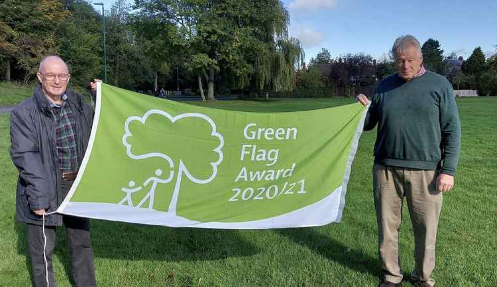 Councillor Roger Bayliss (left), Chairman of the Town Council's Parks & Cemetery Committee and Councillor John Coxon (right), Leader of Ashby de la Zouch Town Council with the 'Green Flag' on Ashby Bath Grounds