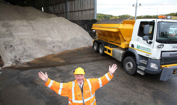 Cllr Trevor Pendleton with a county council gritter and salt stock pile - Ashby roads are being treated in the icy weather