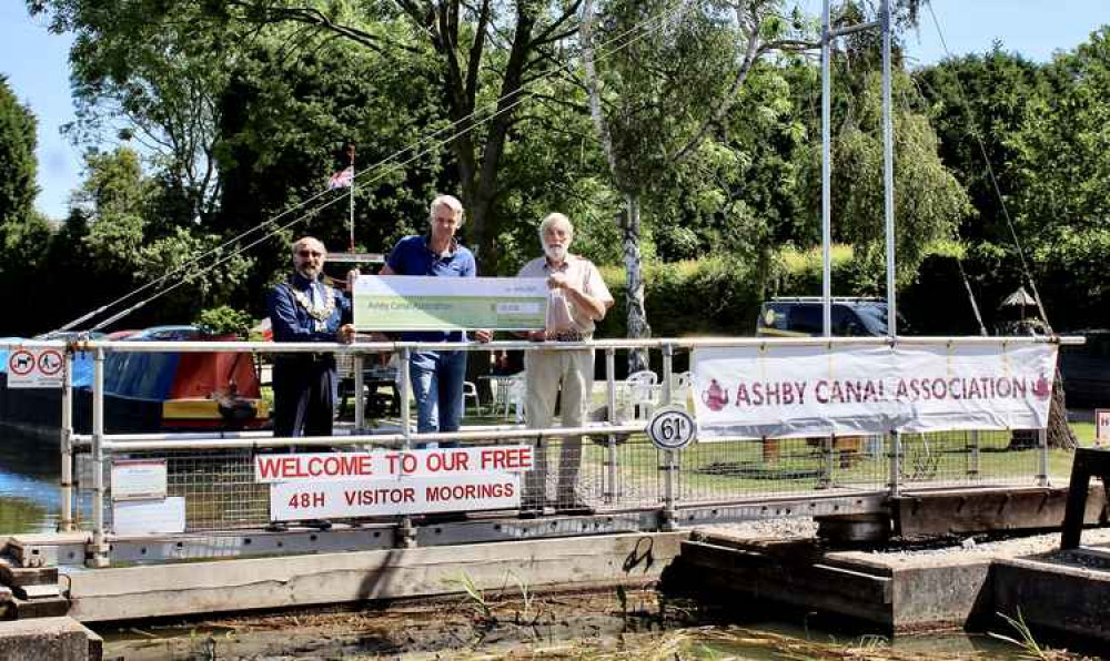 (l-r) North West Leicestershire District Council chairman Virge Richichi and council leader Richard Blunt presenting a cheque to Peter Oakden, Chairman at Ashby Canal Association