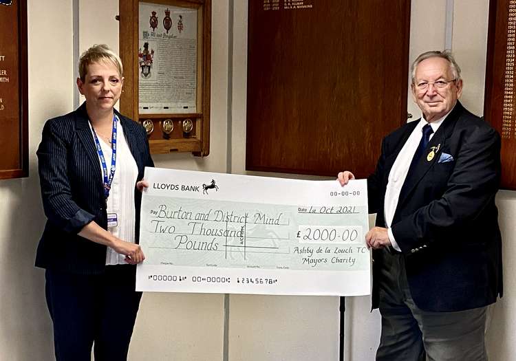 Cllr Graham Allman presents a cheque for £2,000 to Lynne Barrell of Burton & District Mind. Photo: Ashby Nub News Cllr Graham Allman presents a cheque for £2,000 to Lynne Barrell of Burton & District Mind. Photo: Ashby Nub News