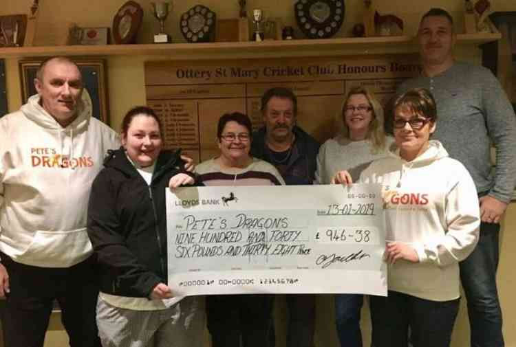 Gemma Youlden presents a cheque for £946 from last year's event to Pete's Dragons trustee and fellow Ottery St Mary resident Lesley Rowland. Also pictured (l-r) are Graham Rowland, Caroline and Dave Youlden, and Vicky and Rob Johns of Ottery Cricke