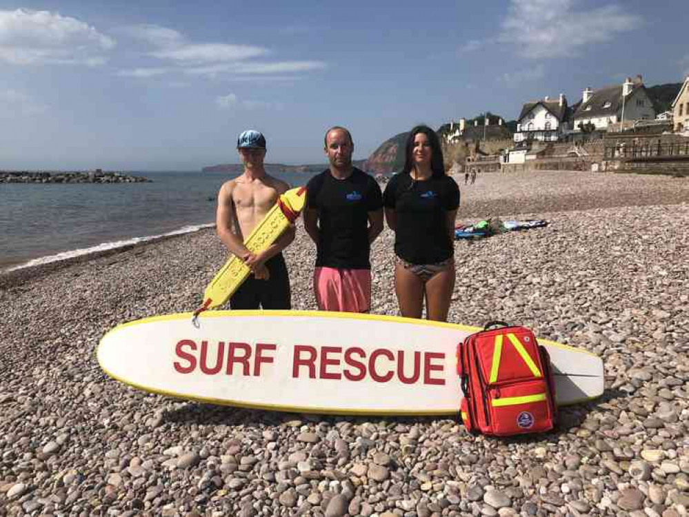 Guy Russell flanked by fellow Sidmouth surf lifesaving club members Maddie Todd and Josh Roberts.