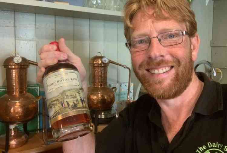 Sidmouth Distillery owner John Hammond with a bottle of Sidmouth Port Royal Rum.