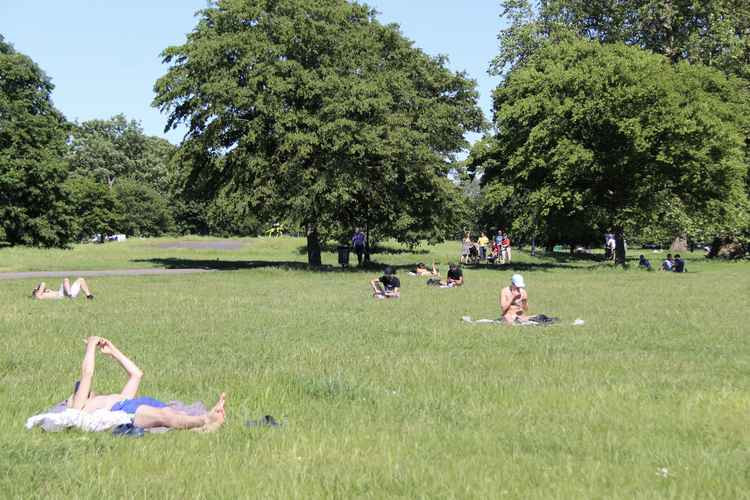 Sunbathers are already out in full force on Clapham Common (Image: Issy Millett, Nub News)