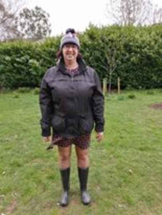 Tracey Pile dodged the showers to don her hat