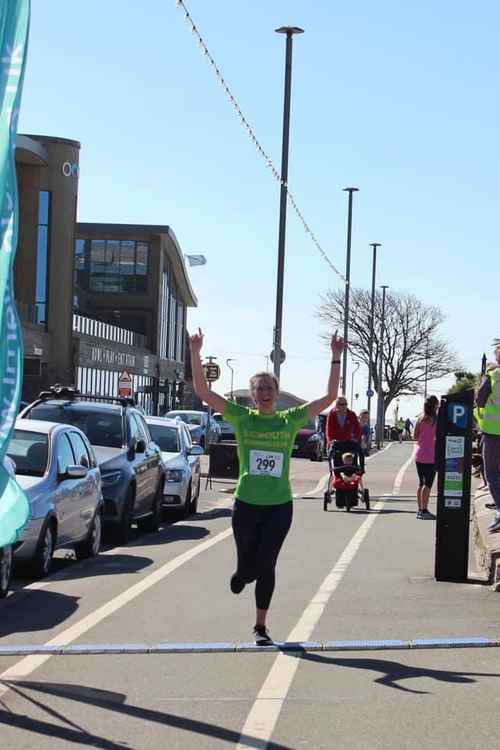 Yasmin Salter flying over the finish line