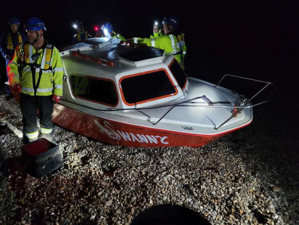 The capsized boat is pulled on to Beer beach after the major rescue operation (photo credit: Beer Coastguards)