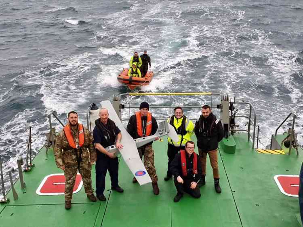 Members of 700X NAS aboard a civilian boat in Falmouth Bay, including (second from left) squadron CO Lt Cdr Justin Matthews