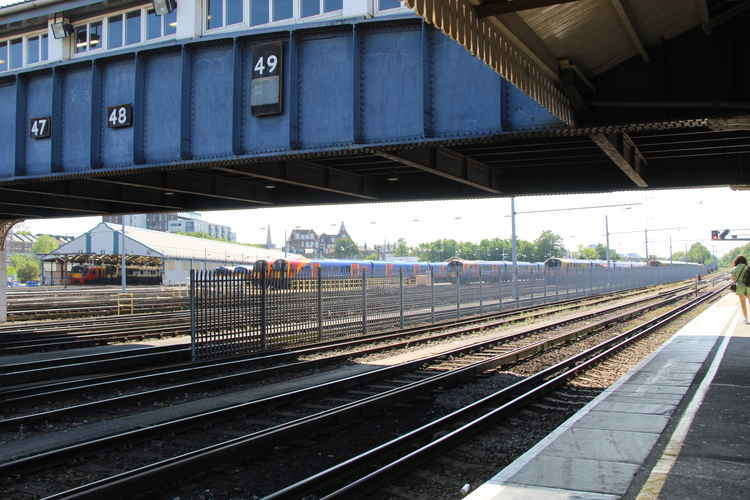 Train services through Clapham Junction are delayed or cancelled following heavy rain flooding UK railways (Image: Issy Millett, Nub News)