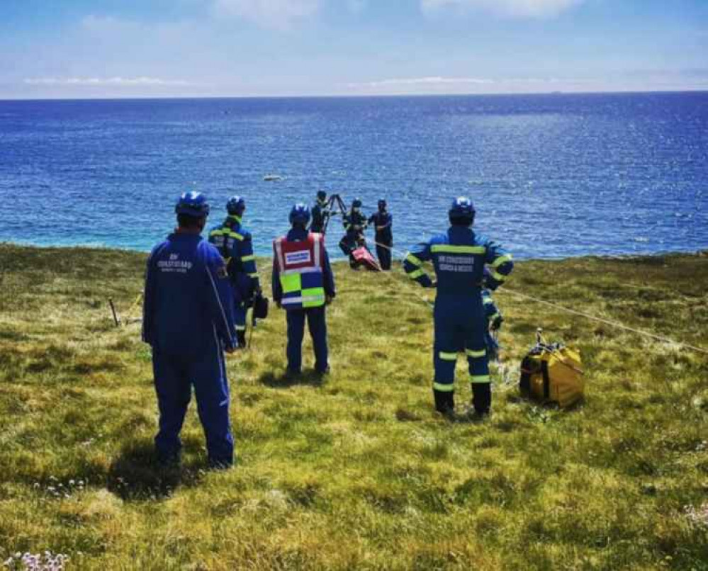 Photo of the team working to extract the dogs and their owner. Taken by Mullion Coastguard.