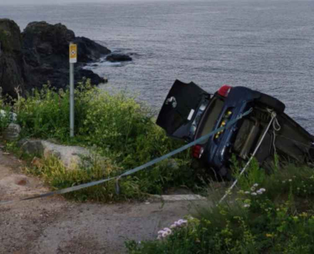 The car hanging over the cliff. Credit: Mullion Coastguard Rescue Team.