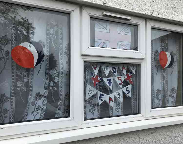 Bunting already in a window in Leigh-on-Mendip