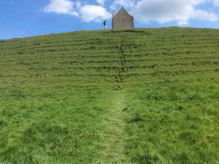 Mike Kelham reaches to top for one of his 100 climbs