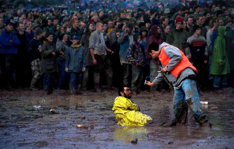 Festival-goer stuck in the mud, 1990s (Photo: Ann Cook/V&A)
