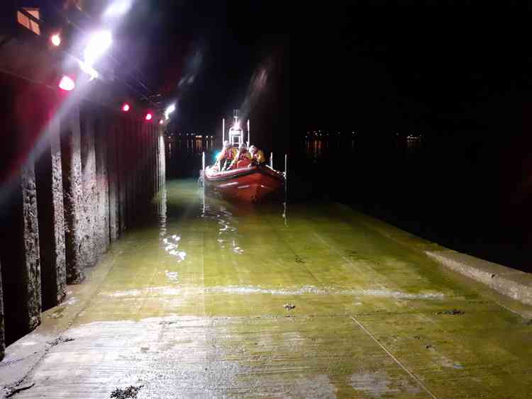 Image shows the volunteer crew and inshore lifeboat heading out to the rescue (Falmouth RNLI)