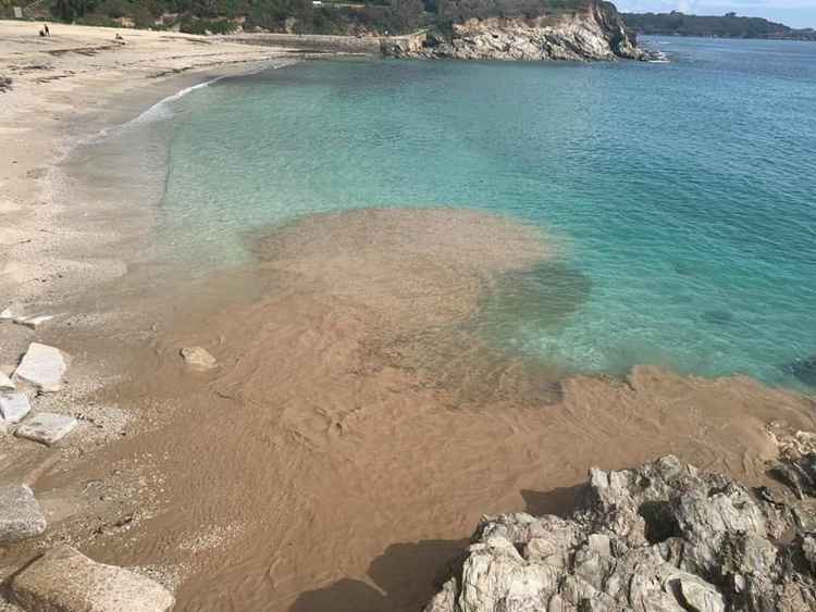 The murky waste running into Swanpool Beach.