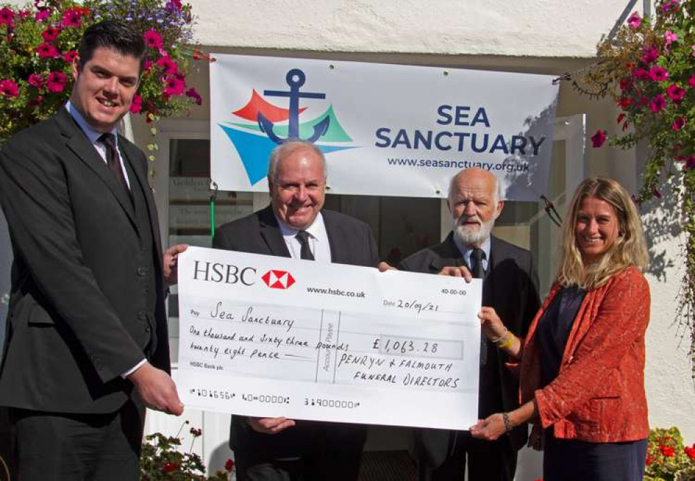 Robin Hattswell-Burt, Daniel Shermon and Roy Sanders of Penryn and Falmouth Funeral Directors  present a cheque to Claire Watt of Sea Sanctuary.