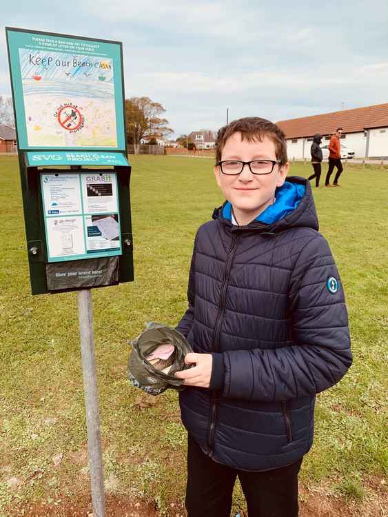 Robin Bevan-Mohaffel, age 13, was first person to fill a bag with five pieces of litter from the beach