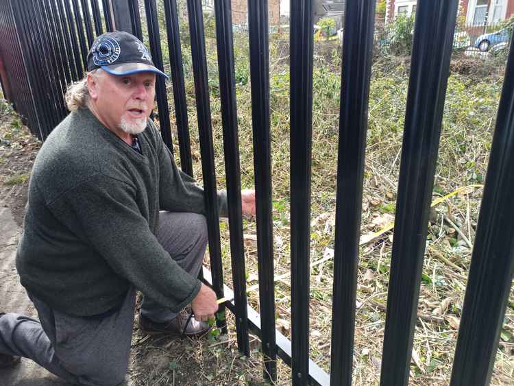 Mr Canlan shows how nine feet of vegetation has been removed from outside his house.