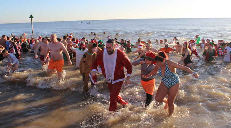 Charity swimmers in the sea at Felixstowe beach at Christmas