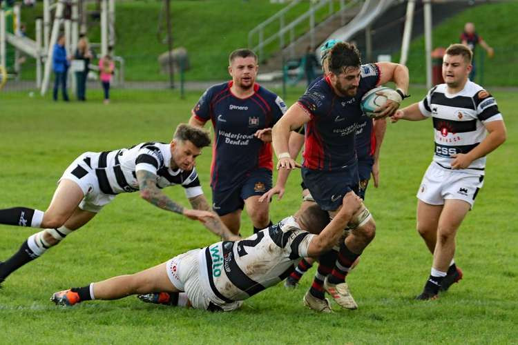 Alex Thau heads for the line as Harry Wood looks on