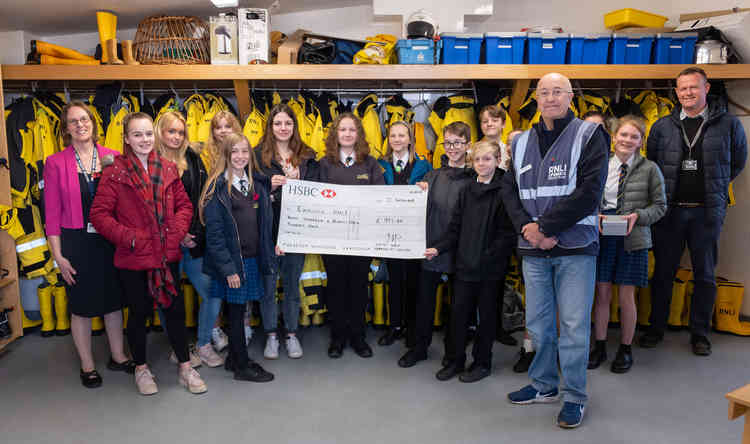 Students from Clyst Vale Community College present their cheque to Exmouth RNLI Lifeboat Fundraising Committee Chairman, Robin Humphreys.