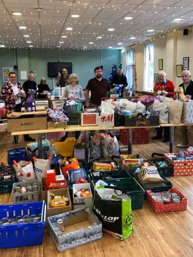 Happy elves helping with last year's hampers.