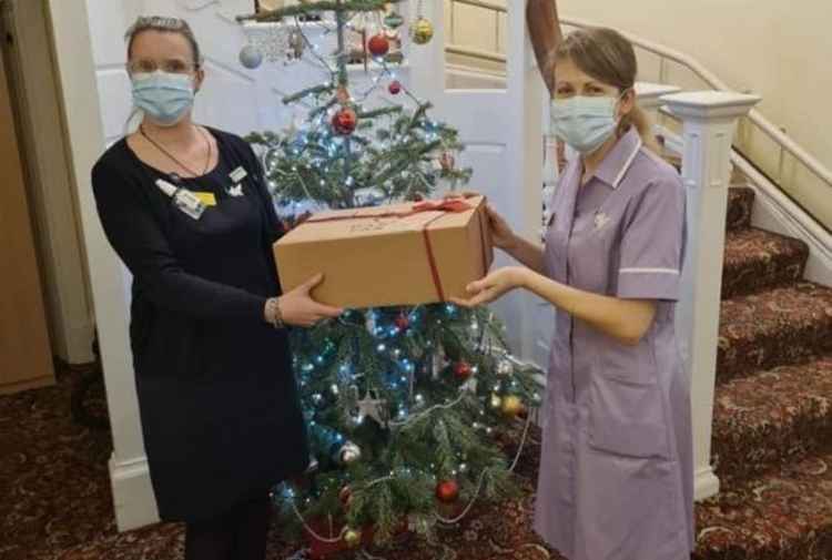 Presenting a Christmas hamper to a member of staff