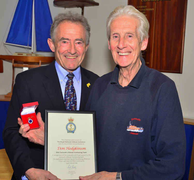 Exmouth RNLI Volunteer Don Hodgkinson receiving his 20 year badge and certificate from former RNLI Chairman, Charles Hunter-Pease.